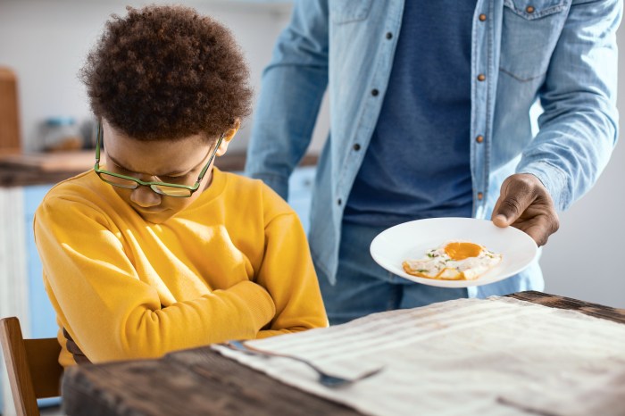 Stubborn pre-teen boy not wanting fried egg for breakfast